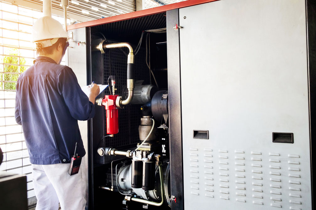 Technician repairing commercial a/c unit