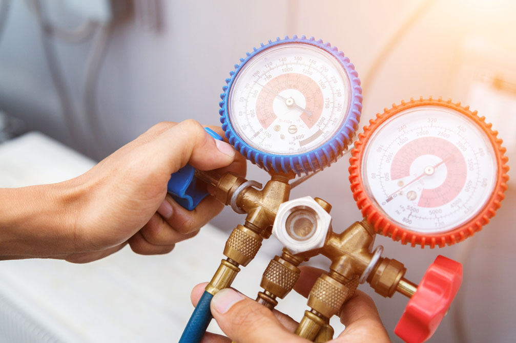 Technician diagnosing a/c unit